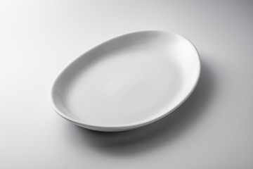 Isolated empty white oval plate