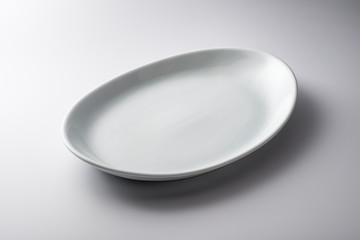 Isolated empty white oval plate