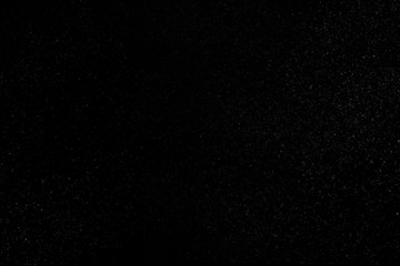 Abstract real dust floating over black background