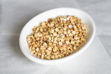 Buckwheat grains on a white plate