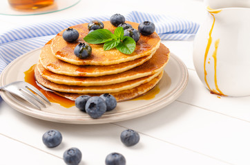 Stack of pancakes with fresh blueberry and caramel syrup