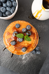 Stack of pancakes with fresh blueberry and caramel syrup