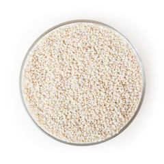 Sesame seeds in glass bowl isolated on white background with clipping path