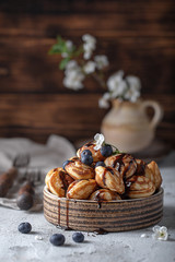 chocolate and blueberry pancakes in a ceramic bowl