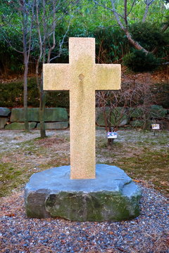 Stone christcross in the park of Jeoldusan Martyrs' Shrine.