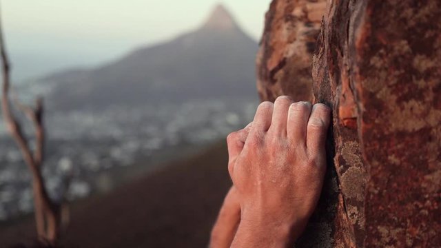 Closeup Of Climbers hand Gripping While Rock Climbing