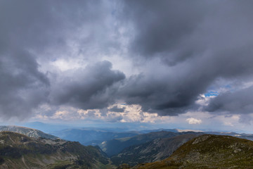 Obraz na płótnie Canvas Beautiful cloudy landscape in the Alps, in summer