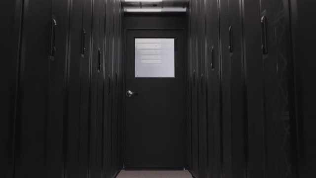 Dark Corridor In Server Room Of Data Center With Cloud Digital Storage. Mining Farm And Internet Information Technology Concept, No People Around. Computer Routers In Racks On The Rows Isolated