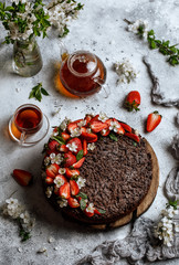 Chocolate round cake with strawberry. Tasty chocolate grated pie