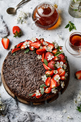 Chocolate round cake with strawberry. Tasty chocolate grated pie