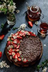 Chocolate round cake with strawberry. Tasty chocolate grated pie