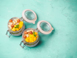 Chia seed pudding in jar with coconut milk, mango and nuts