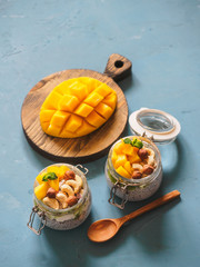 Chia seed pudding in jar with coconut milk, mango and nuts