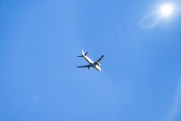 blue sky with plane and sun