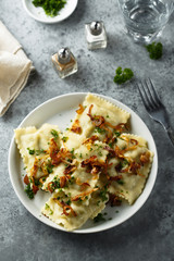 Traditional German dumplings with fried onion and herbs