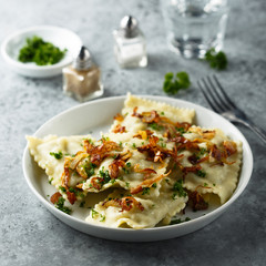 Traditional German dumplings with fried onion and herbs