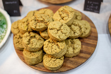 Home made scones served on a wooden plate on the table close up.