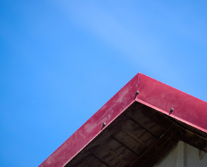 The ridge of the roof, sheathed with red metal.