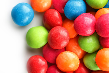 A rainbow of color from multicolored candies close-up, multi-colored glaze dragee on a white background