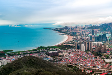 Obraz premium A bird's eye view of Qingdao coastline and urban skyline..