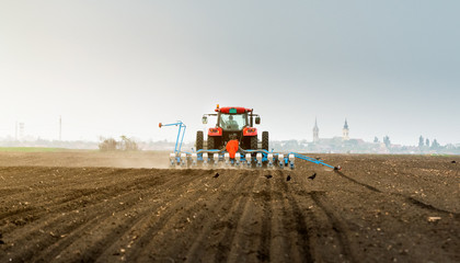  Farmer with tractor seeding soy crops at agricultural field