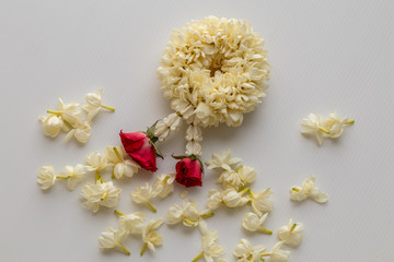 Close up selective focus Jasmine garland of flowers isolate on white background.The Jasmine garland flower in Thai Tradition Style.