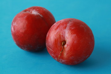 Delicious plums in colorful background