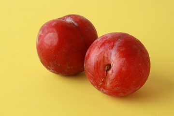 Delicious plums in colorful background