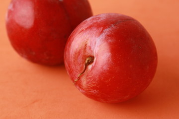 Delicious plums in colorful background