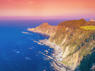 Aerial view of ocean and rocky coast at sunset. Galicia, Spain