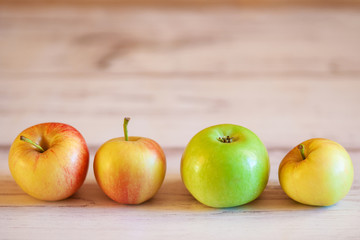 Fresh organic apples on a wooden table. Natural light. Selective focus
