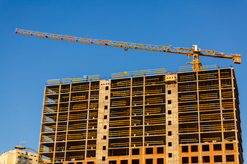 Crane. Construction crane. Building crane on the background of two buildings