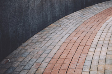 marble, granite wall of a round gray shape with a structure and pavement pavement, tile, which is lined with arc