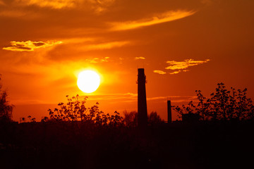 Factory chimney industry in evening sunset background,