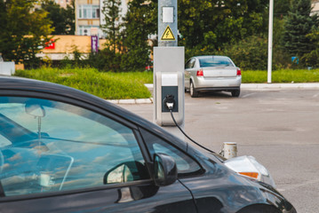Fototapeta premium electric car charging at mall parking aria