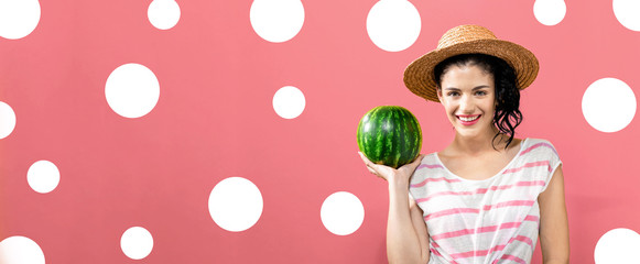 Fototapeta na wymiar Young woman holding watermelon on a solid background