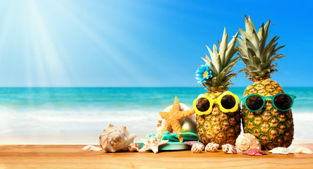 Pineapples with starfish on the tropical beach © Tierney