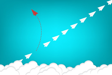 Think different. Think differently concept. Red airplane changing direction. New idea, change, trend, courage, creative solution, innovation and unique way concept.	