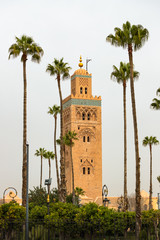 Fototapeta premium Koutoubia mosque in Marrakesh, Morocco, surrounded by palm trees