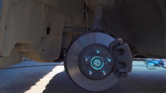 Brake disc and car jack in a car auto service