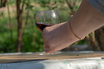 hand holding a glass of red wine