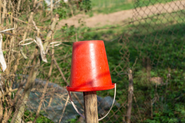 red bucketful on pillar