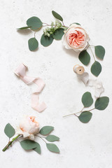 Feminine wedding, birthday still life scene. Silk ribbons, eucalyptus leaves and blush pink English...