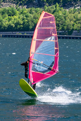 Windsurfer jumping on lake Como