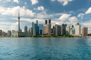 Lake Ontario view, City of Toronto skyline and quays with trees.