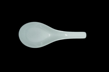Plastic spoon isolated on black background