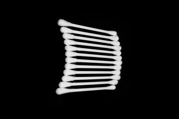 White cotton buds isolated on black background