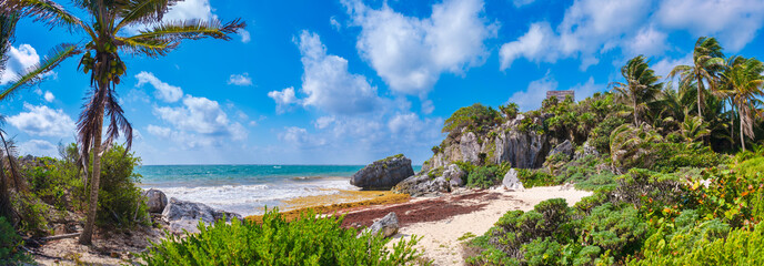 Beautiful beach and mayan ruins on a cliff at Tulum in Mexico