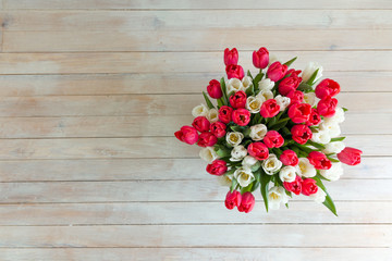 Fototapeta premium Tulips flowers a bouquet of flowers wooden background