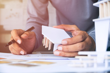 architect design working drawing sketch plans blueprints and making architectural construction model in architect studio